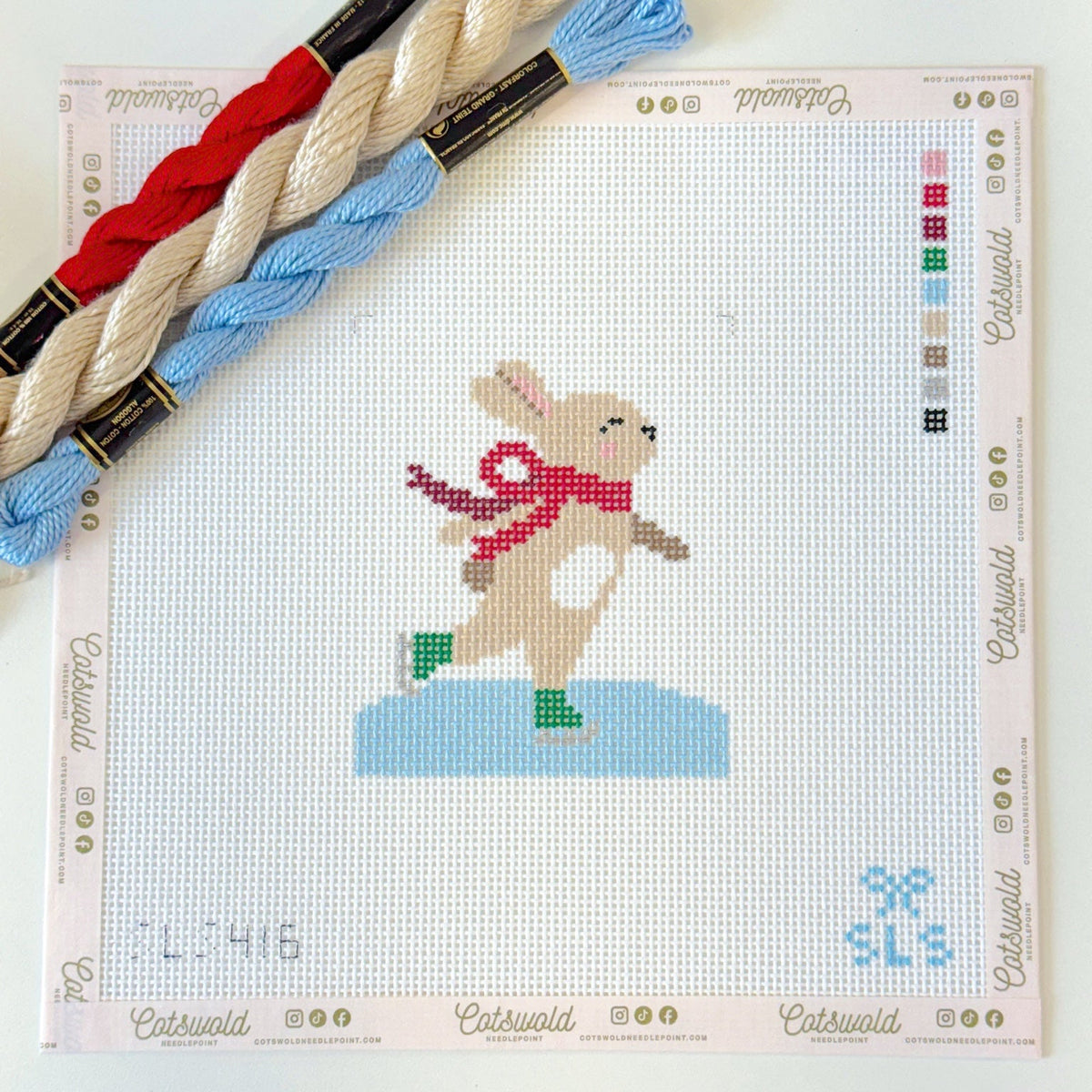 Ice skating bunny needlepoint canvas styled with blue red and ivory threads