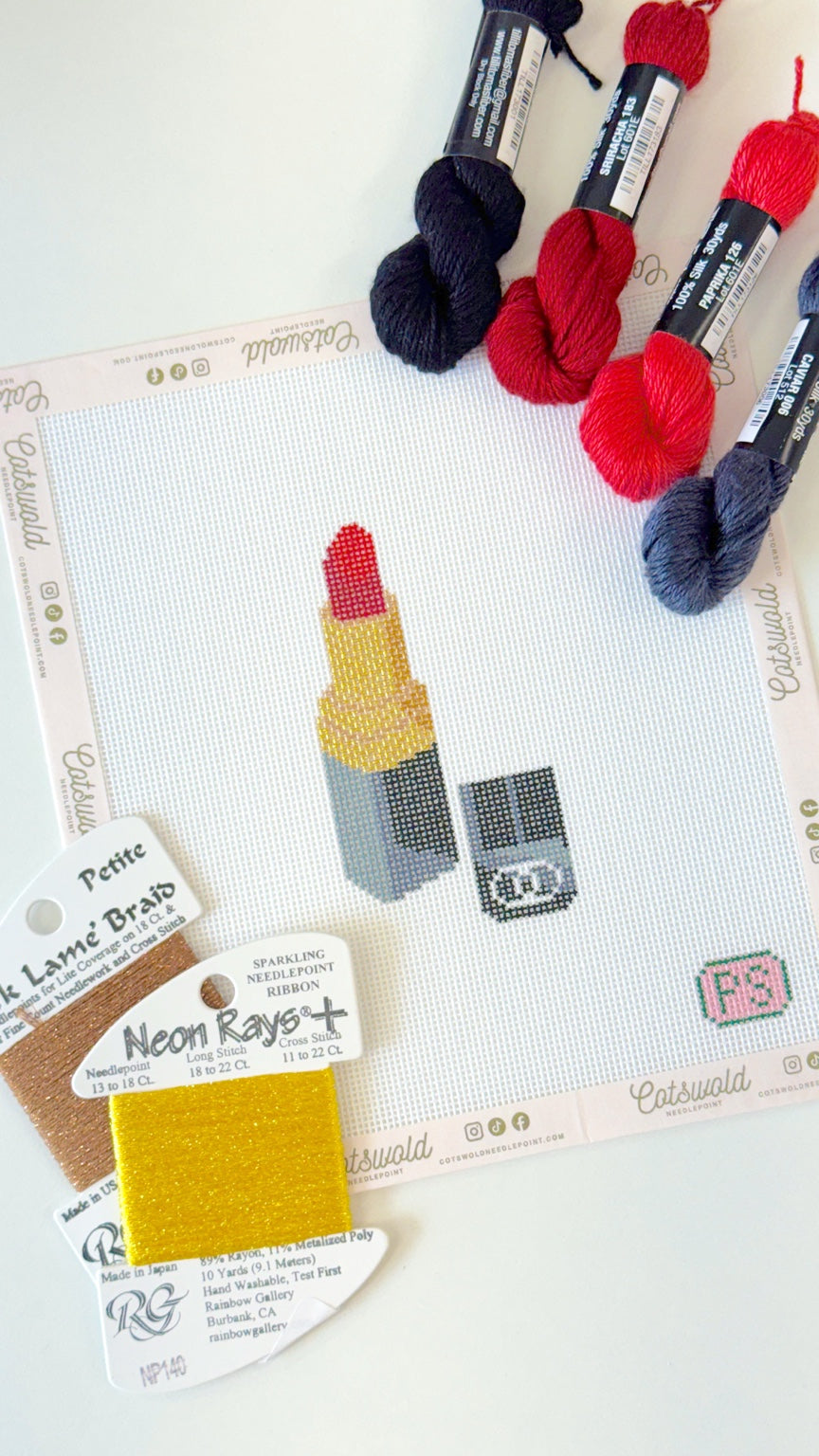 Red lipstick makeup needlepoint canvas styled with coordinating fibers and threads