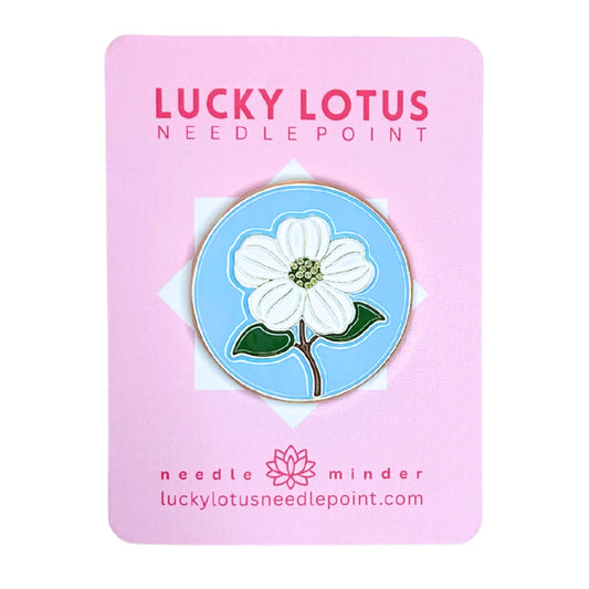 Floral pin on a pink card with 'Lucky Lotus Needle Point' branding