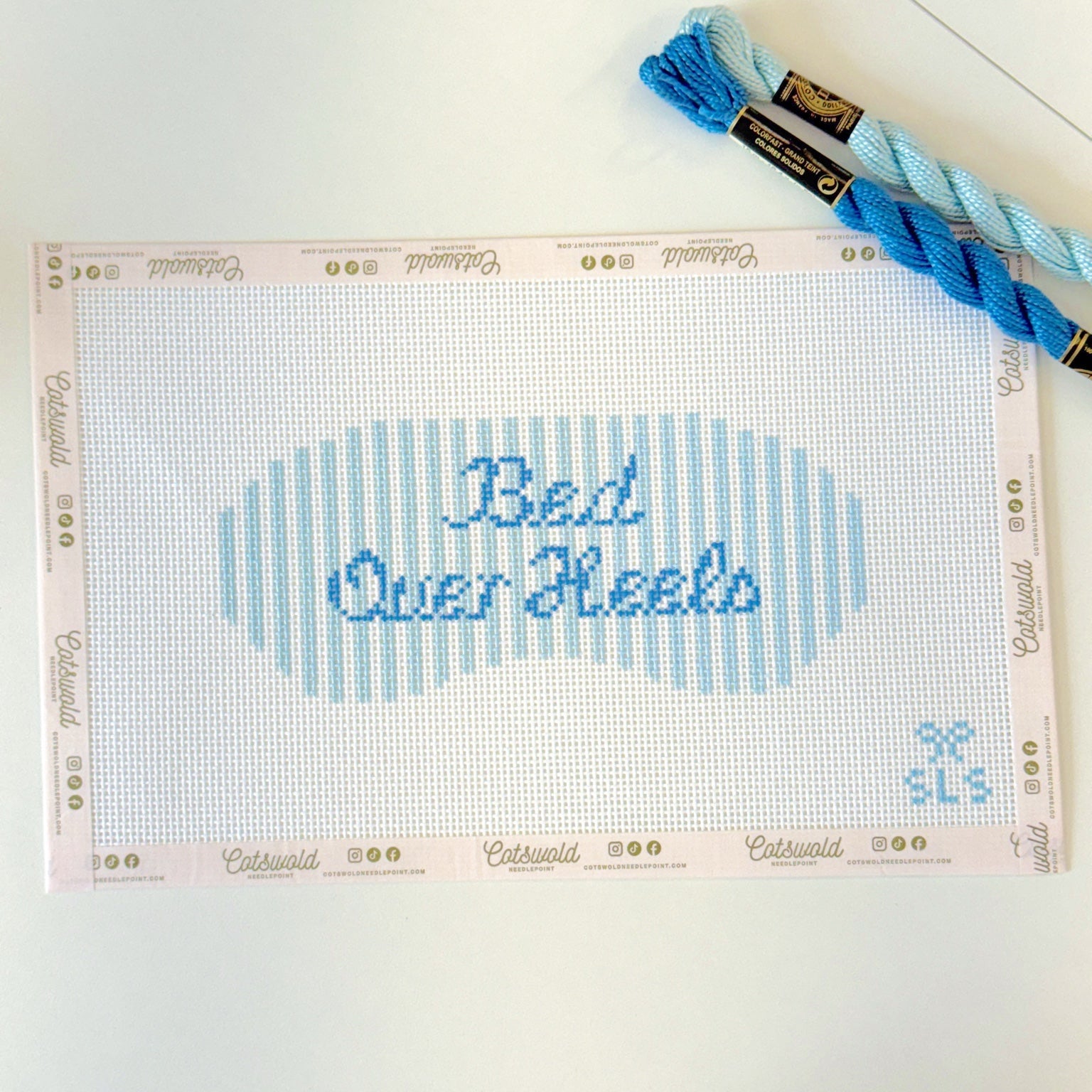 Bed Over Heels blue phrase needlepoint canvas styled with coordinating blue threads