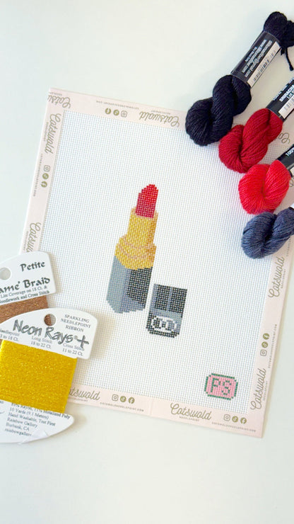 Red lipstick makeup needlepoint canvas angled view with coordinating red and black threads